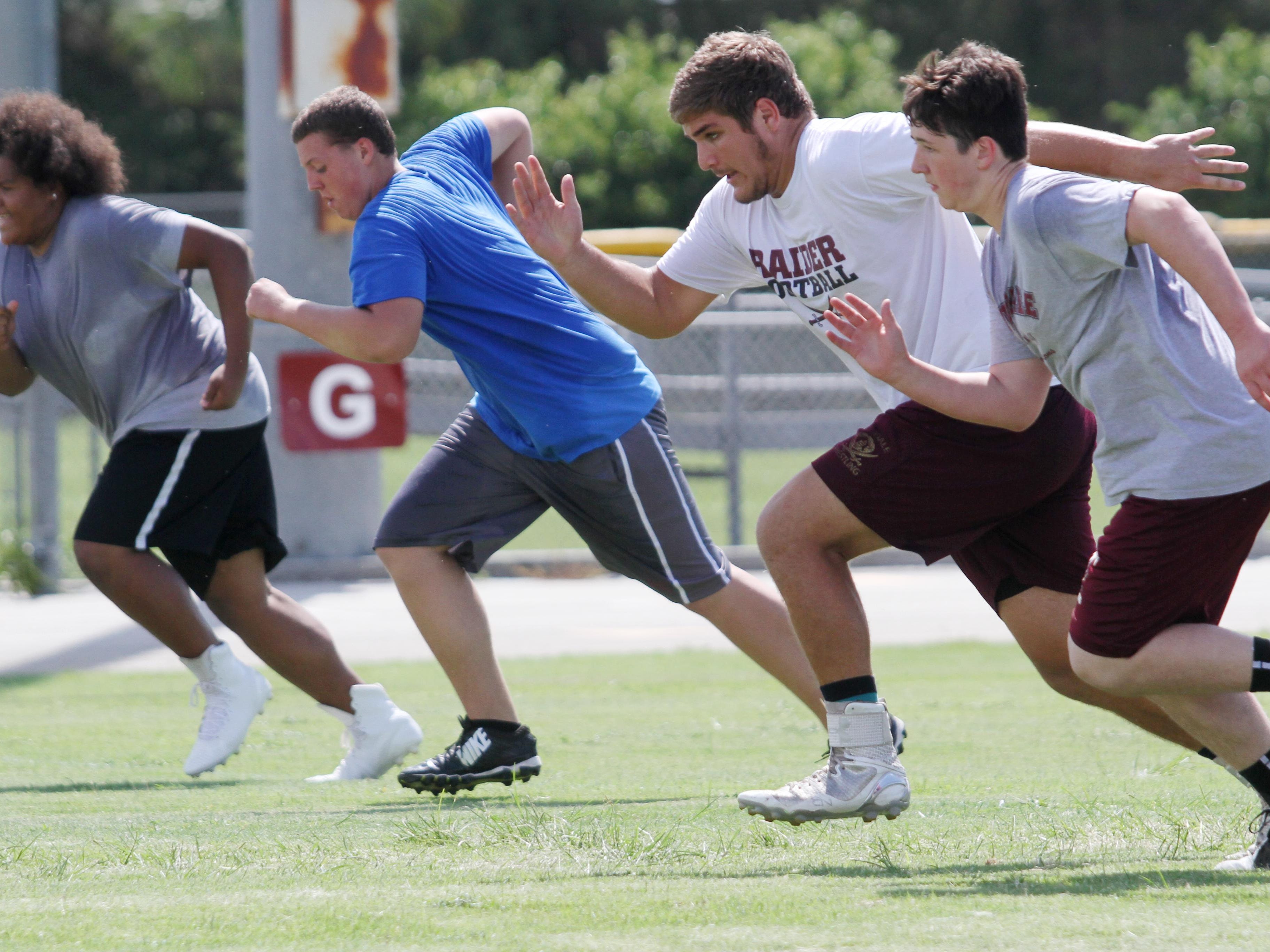 Riverdale’s Cole Schneider, 2nd from right, runs sprints during summer practice last week.
