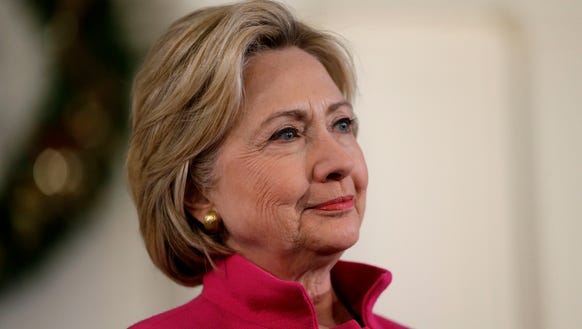 Democratic presidential candidate Hillary Clinton listens