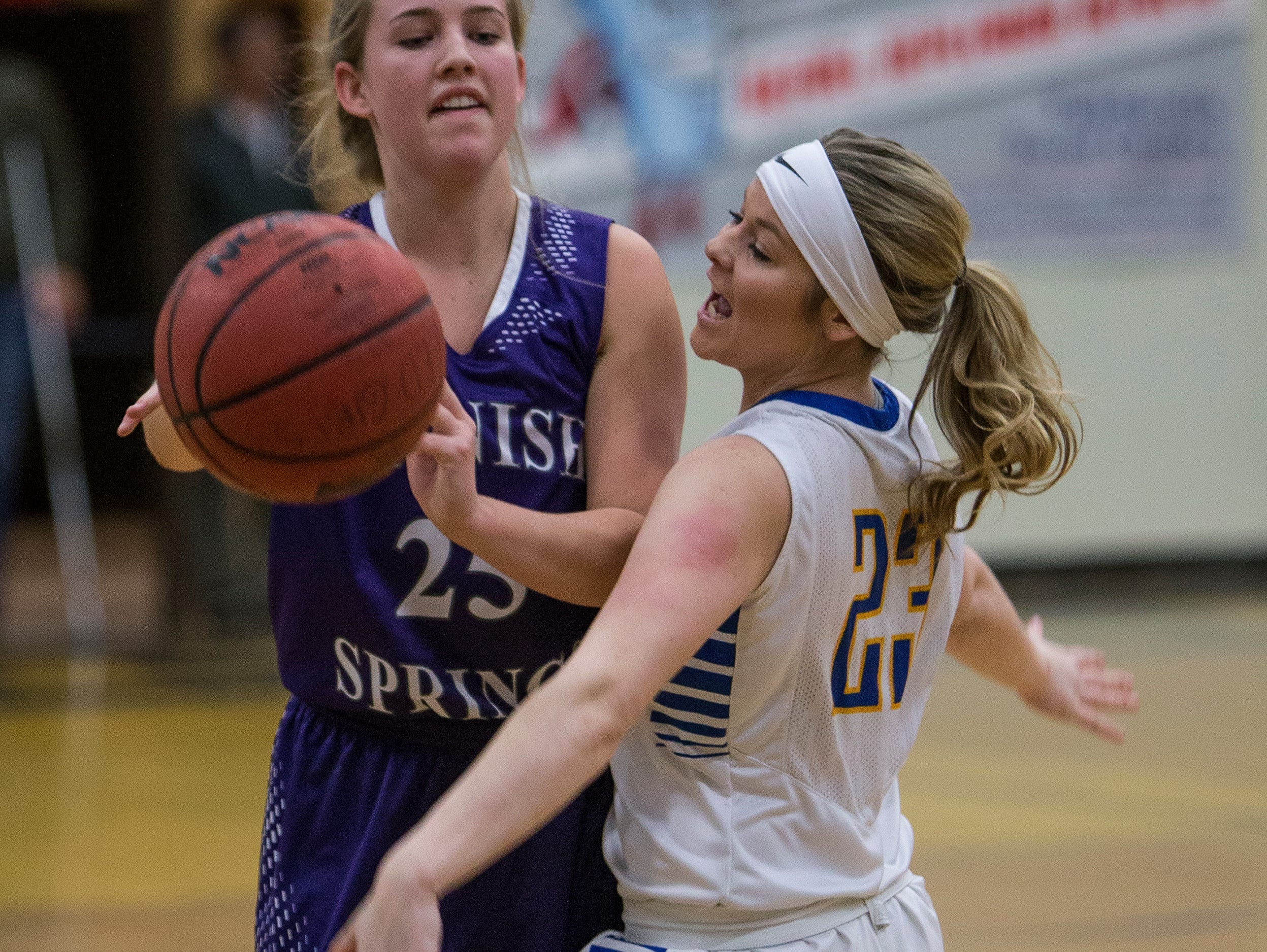 Spanish Springs Cougars Mackenzie O'Connell passes as Reed Raiders Gabby Kahl defends in their basketball game played on Friday night, at Reed.