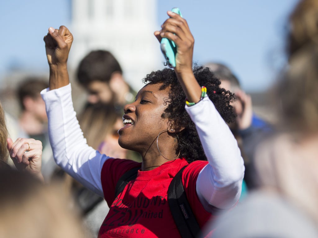 Protesters celebrate the resignation of Missouri University president Timothy Wolfe on the Missouri University campus in Columbia, Mo. Wolfe resigned after pressure from students and student athletes over his perceived insensitivity to racism on the 