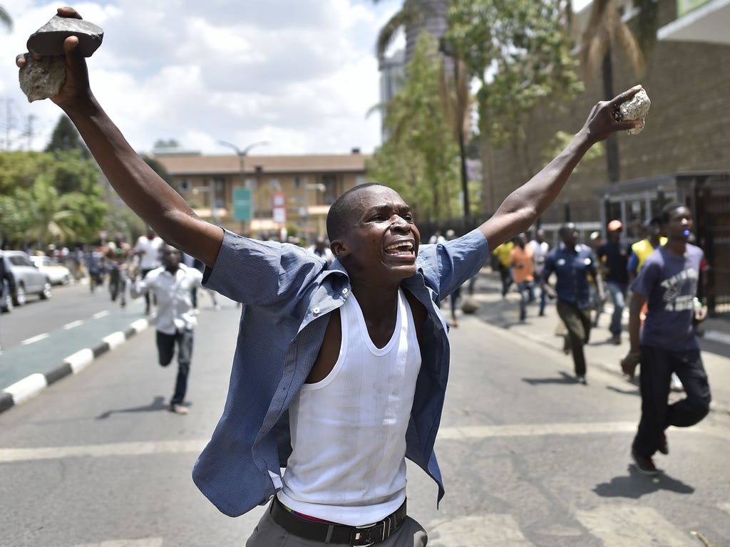A supporter of the opposition-led National Super Alliance (NASA) gestures and holds stones in Nairobi on Oct. 11, 2017, during street protests by NASA to call for the resignation of Independent Electoral and Boundaries Commission (IEBC) officials ove