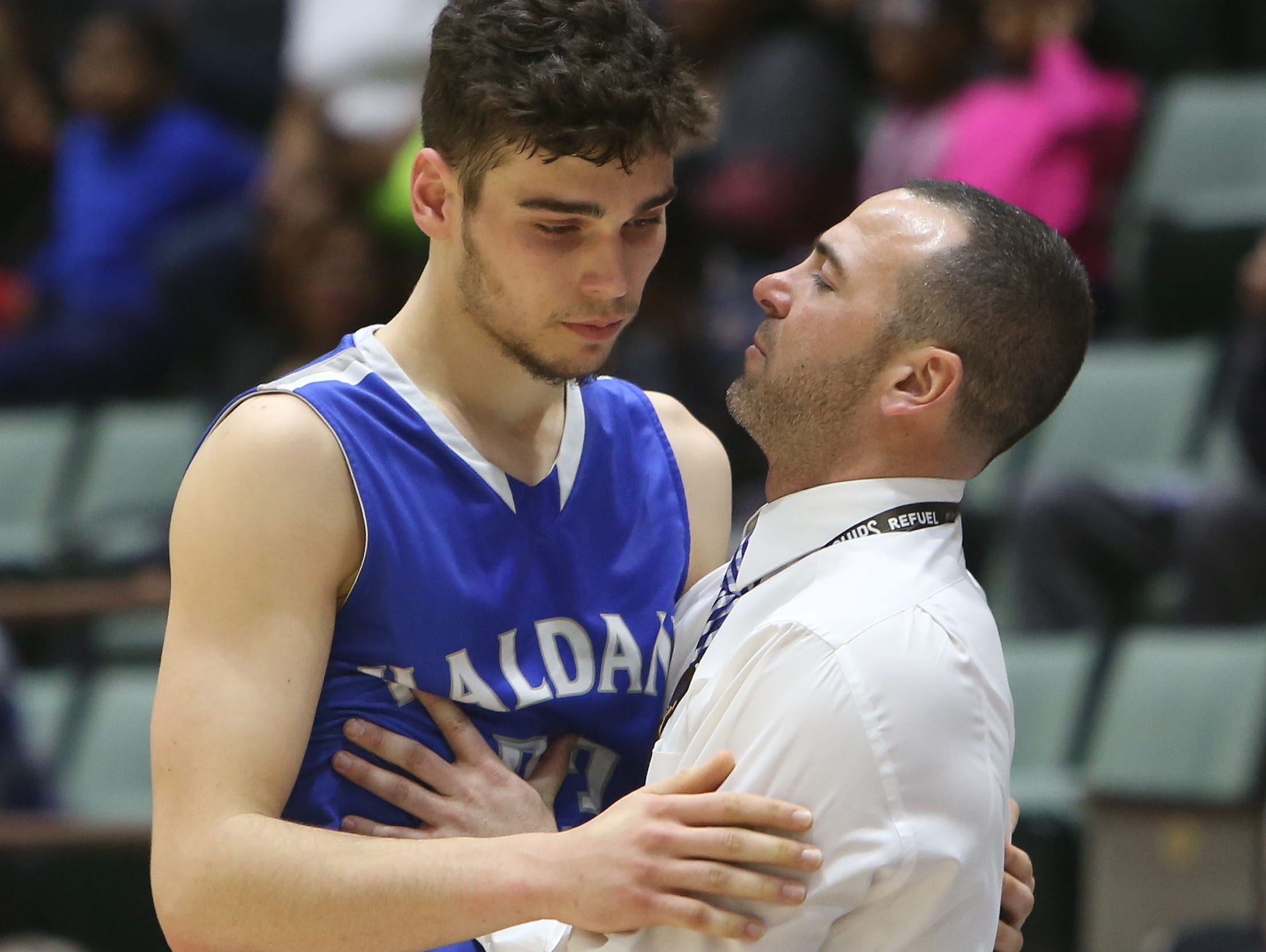 Haldane's Will Zuvic (33) is consoled by coach Joe Virgadamo as he comes out of the game against Middle Early College during the New York State boys basketball Class C championship game at the Glens Falls Civic Center March 12, 2016. Middle Early College won the game 82-42.