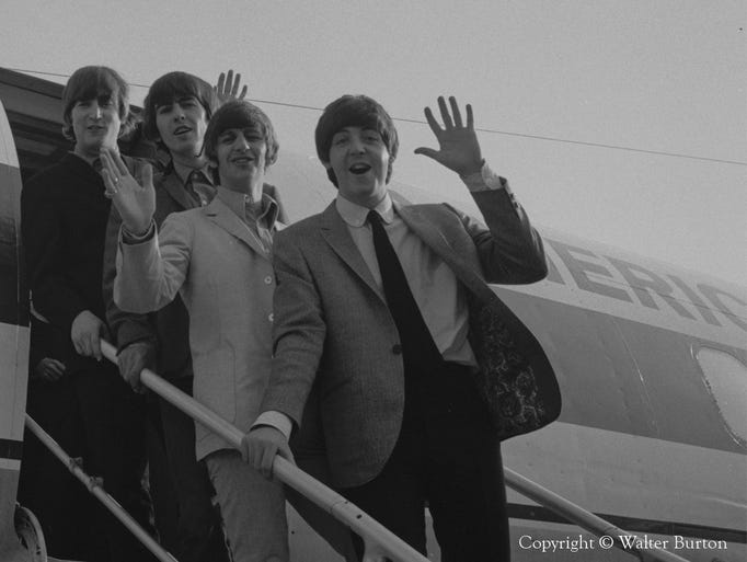 The Beatles wave upon exiting their plane at Lunken Airport.