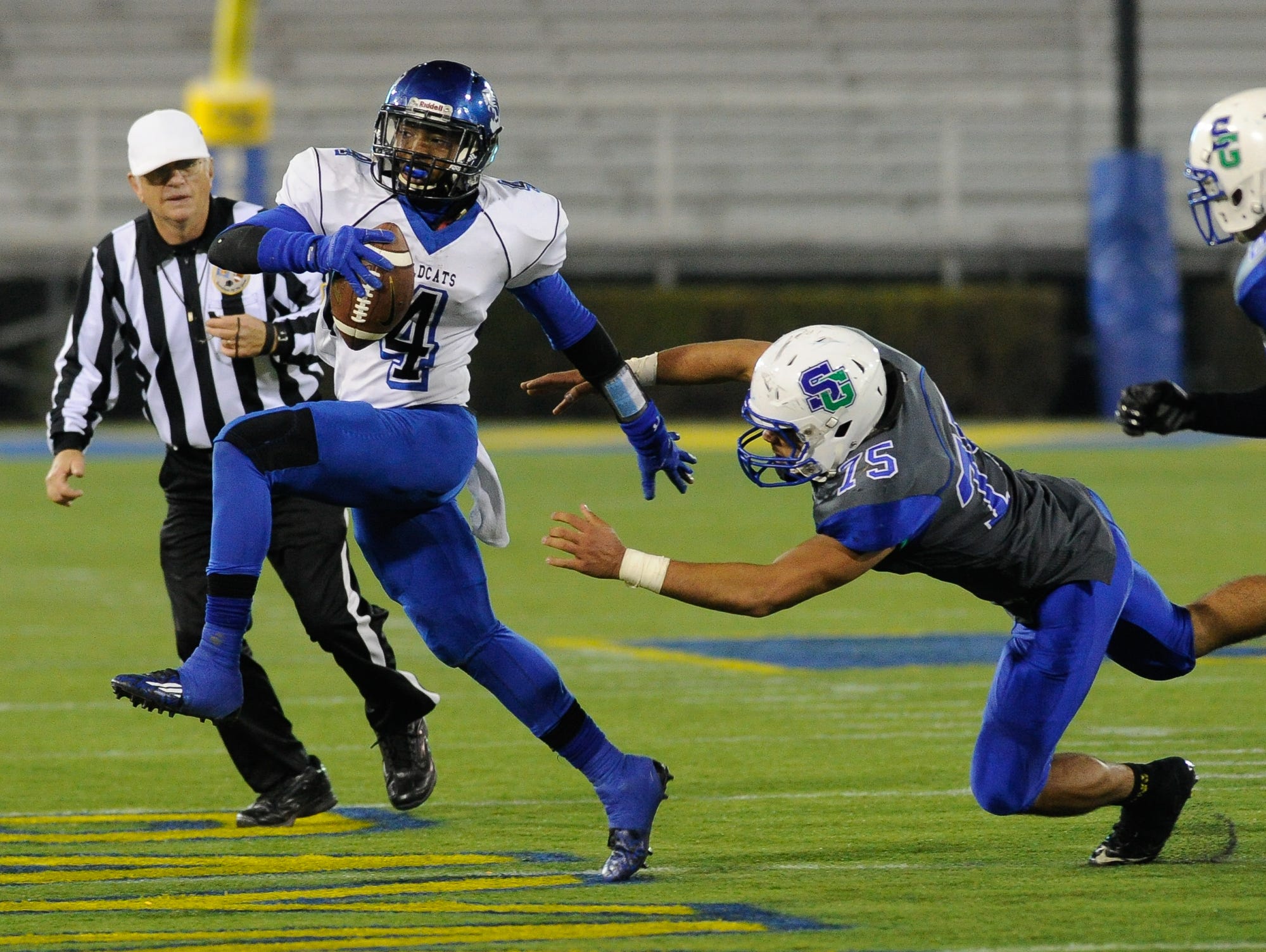 Howard's quarterback #4 Earnest Austin evades a tackler during the Division II championship against St. George's.