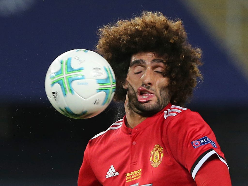 Manchester United's Marouane Fellaini takes a ball to the face during the UEFA Super Cup final soccer match between Real Madrid and Manchester United at Philip II Arena in Skopje, Macedonia. Real Madrid won the game, 2-1.