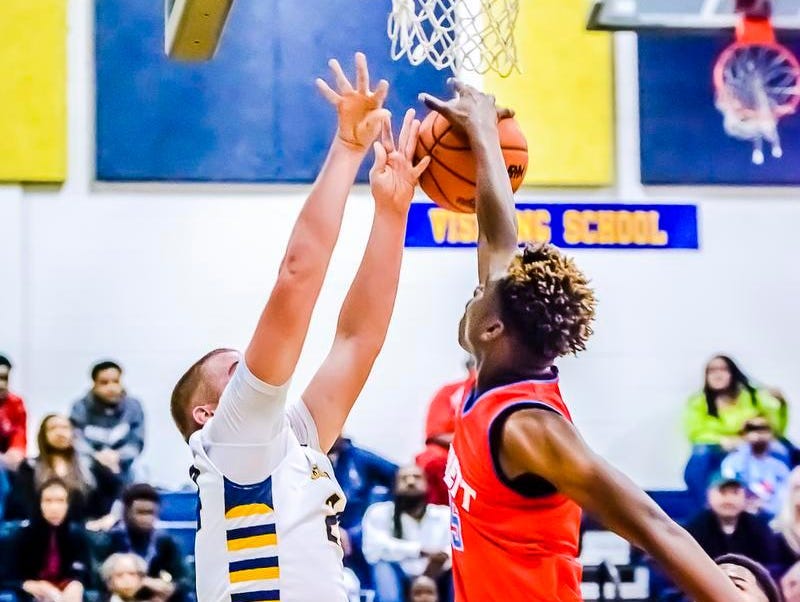 Marquez Gordon ,right, of Everett blocks a shot attempt by Jordon Goebel of Grand Ledge during their game Friday in Grand Ledge.