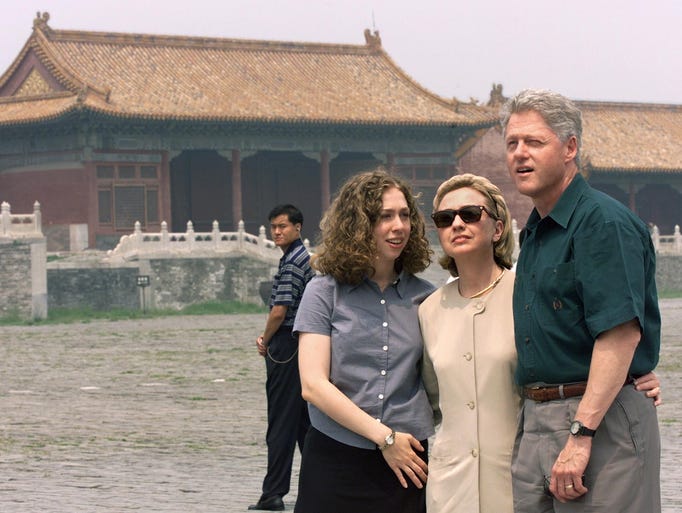 US President Bill Clinton, First Lady Hillary Clinton, and their daughter Chelsea tour the Forbidden City in Beijing, as a Chinese security agent (rear) looks on 28 June during their 9 day official trip to China. The three later toured the Great Wall.