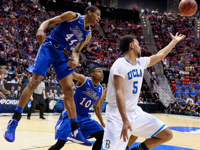 UCLA Bruins guard/forward Kyle Anderson reaches for the ball as Tulsa Golden Hurricane Brandon Swannegan, left, and James Woodard look on at Viejas Arena.