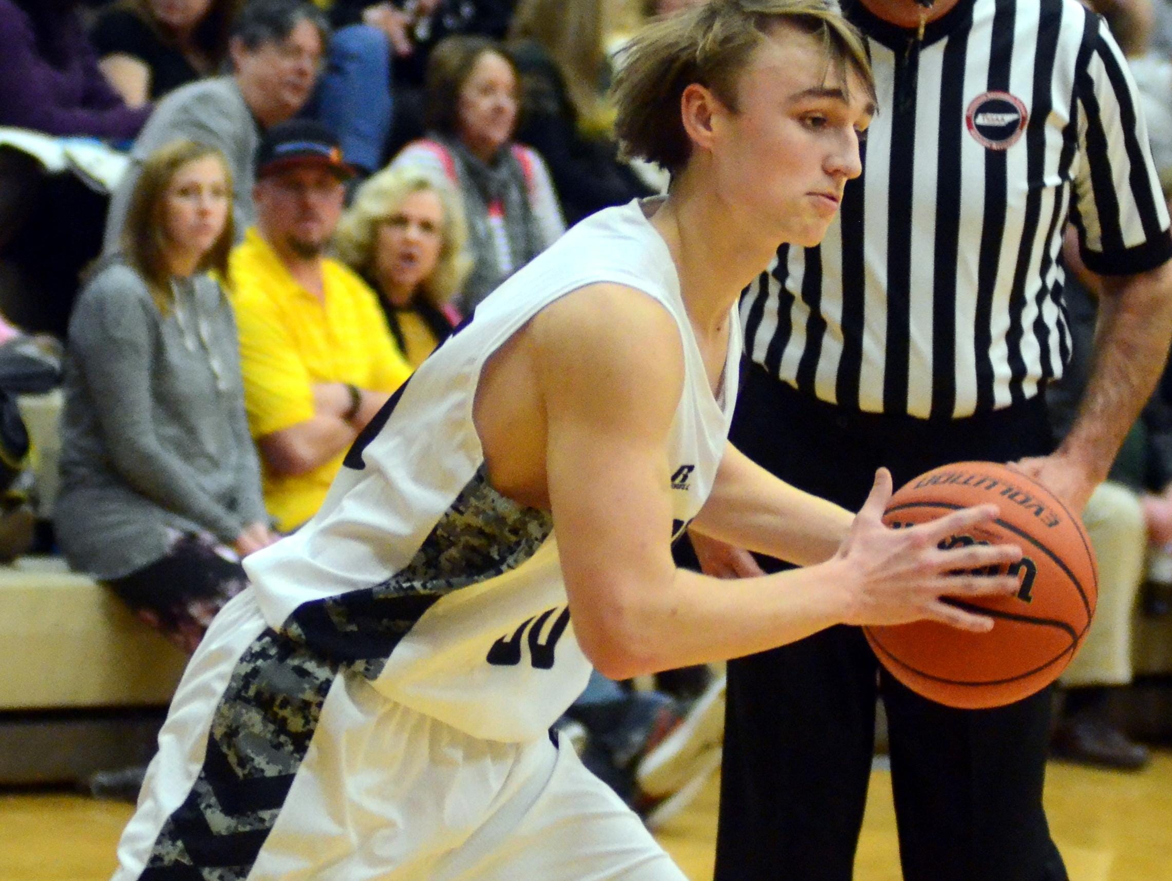 Hendersonville High junior Ryne Loper prepares to drive into the lane during second-quarter action. Loper scored three points.