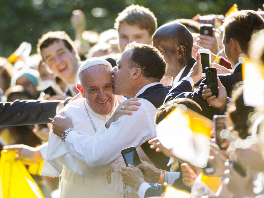 Pope Francis receives a kiss outside the Apostolic Nunciature to the United States  in Washington, D.C.
