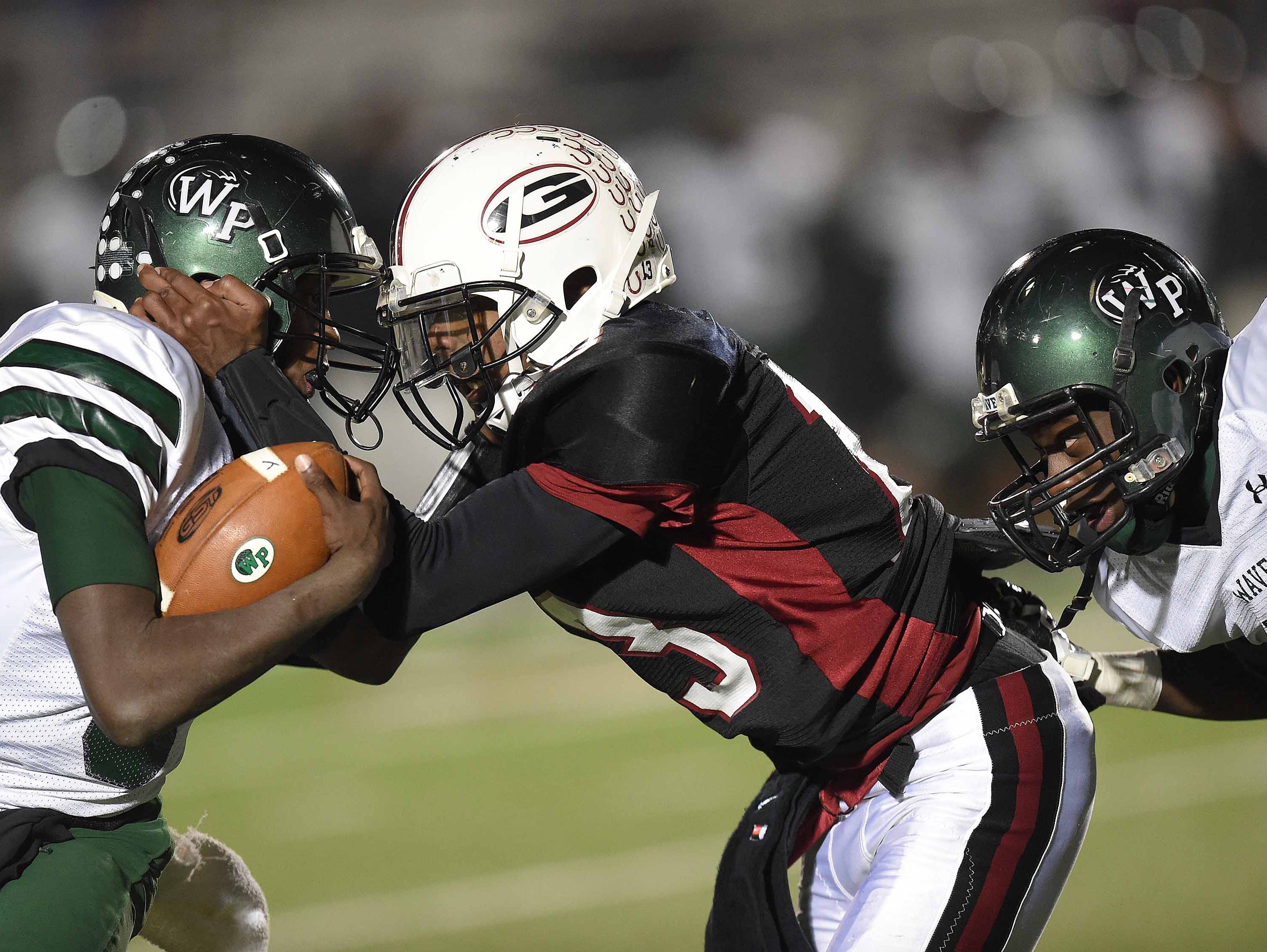 West Point quarterback Dason Thomas (far left) runs into Germantown defender Nigel Knott (center).
