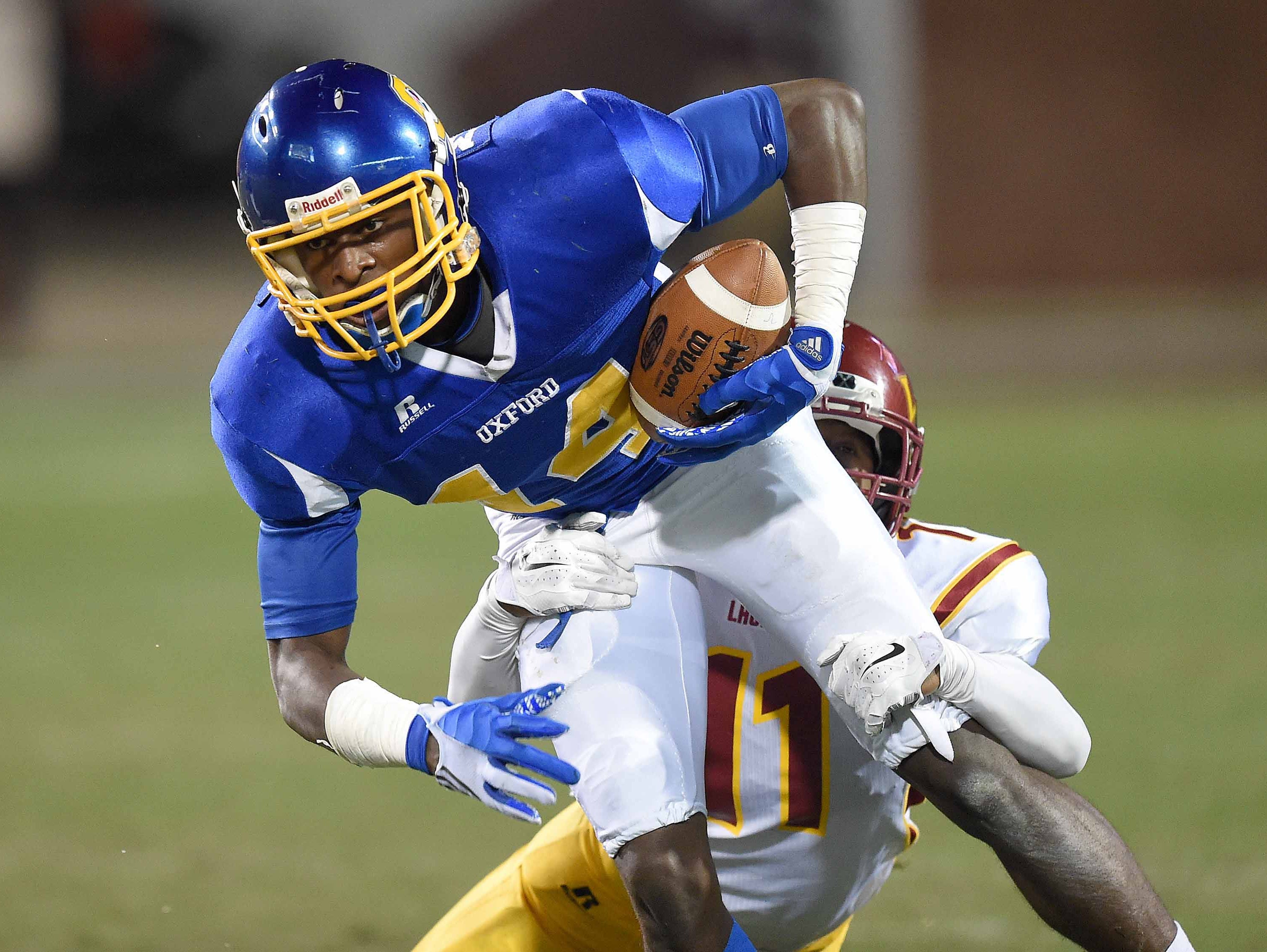 Oxford wide receiver Dekaylin Metcalf tries to break free from Laurel's Shemar Keyes in the MHSAA football state championships on Saturday, December 6, 2014, at Davis Wade Stadium on the Mississippi State University campus in Starkville.