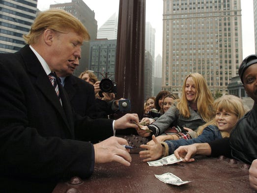 Donald Trump signs autographs for a crowd prior to