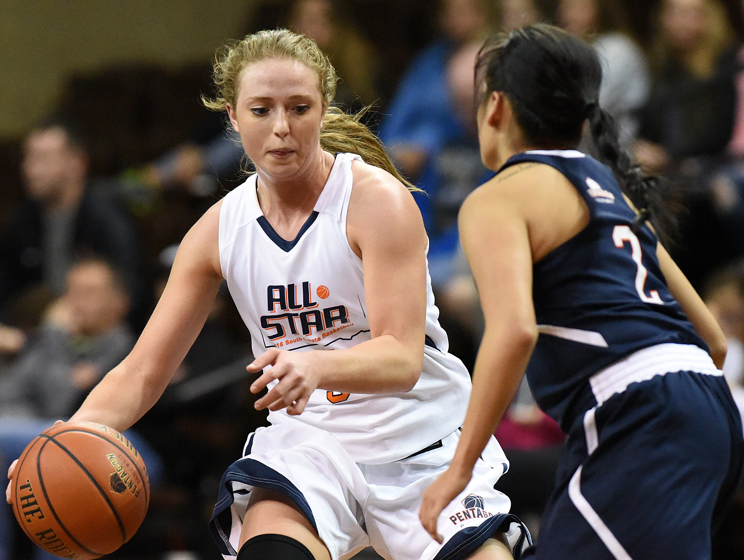 The White Team's Abby Hora (5) drives the ball around the Blue Team's Shaylene Richard (2) during the Argus Leader/Sanford Pentagon First Five All-Star Game on Sunday, April 10, 2016, at the Sanford Pentagon in Sioux Falls.