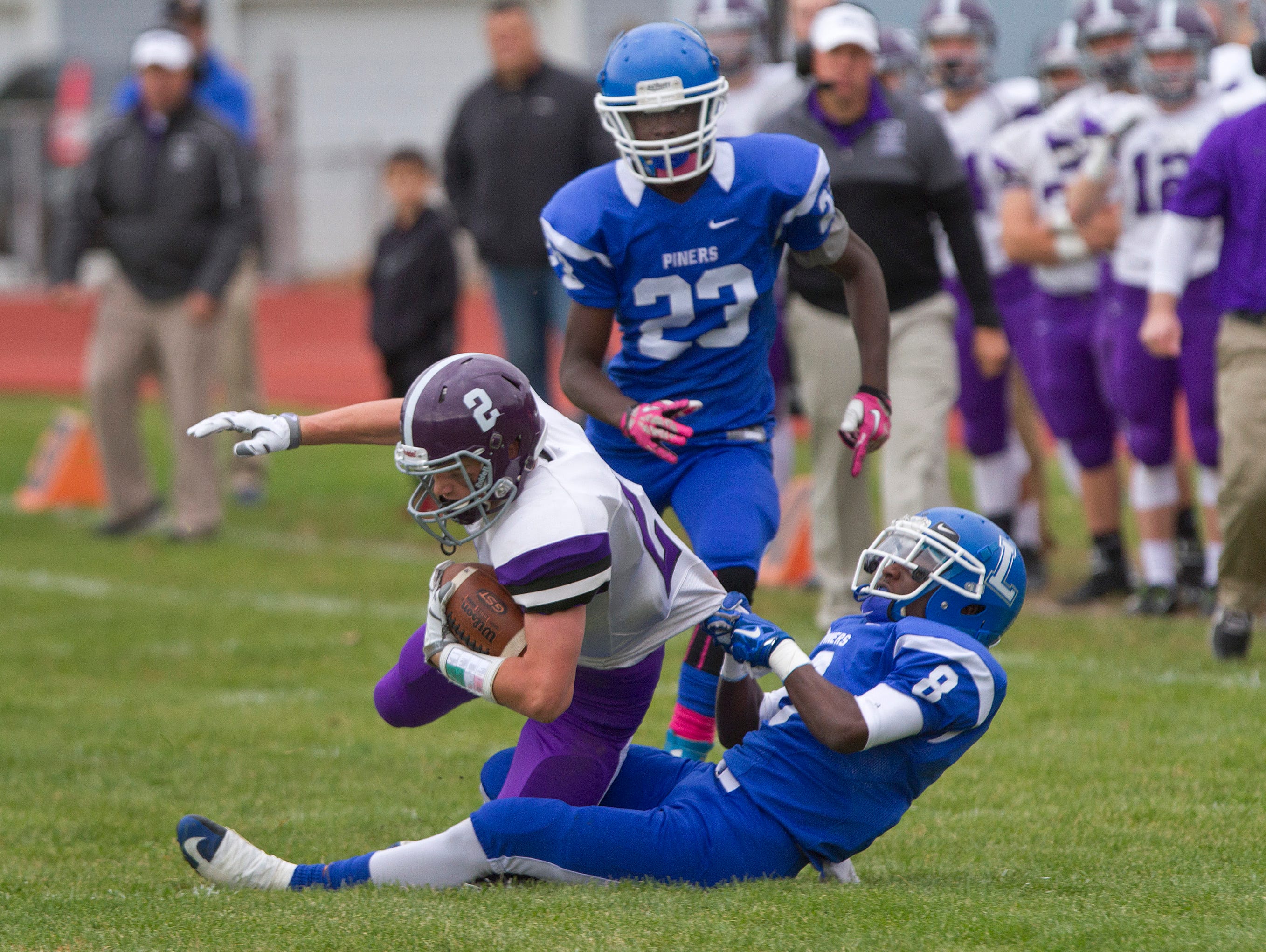 Lakewood's Honore Richardon wrestles Rumson's Lachlan Hull to the ground during Rumson-Fair Haven Football vs Lakewood in Lakewood, NJ on October 24, 2015
