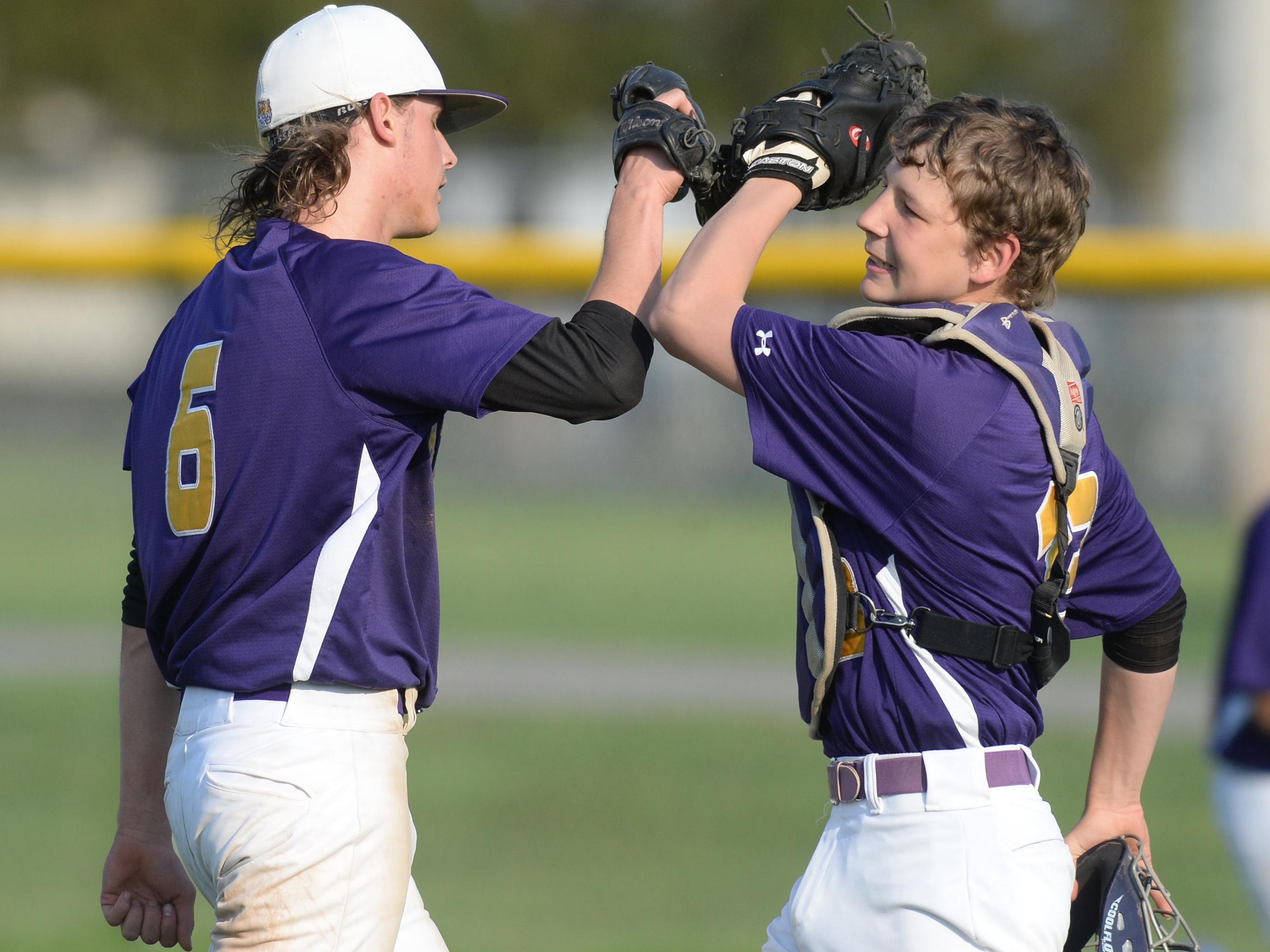 Hagerstown’s Sam Reagan is greeted by catcher Cameron Purtha after a game. The Tigers, the defending TEC champion, will play Class A Sectional 56 next season.