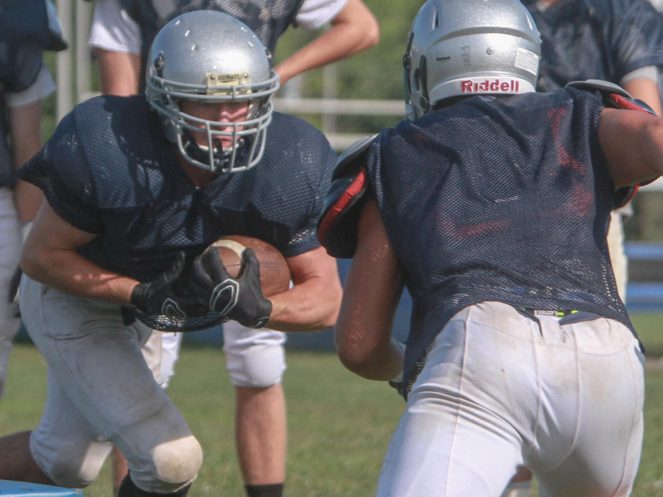 Paul Krueger takes the handoff for Manasquan during practice this summer.