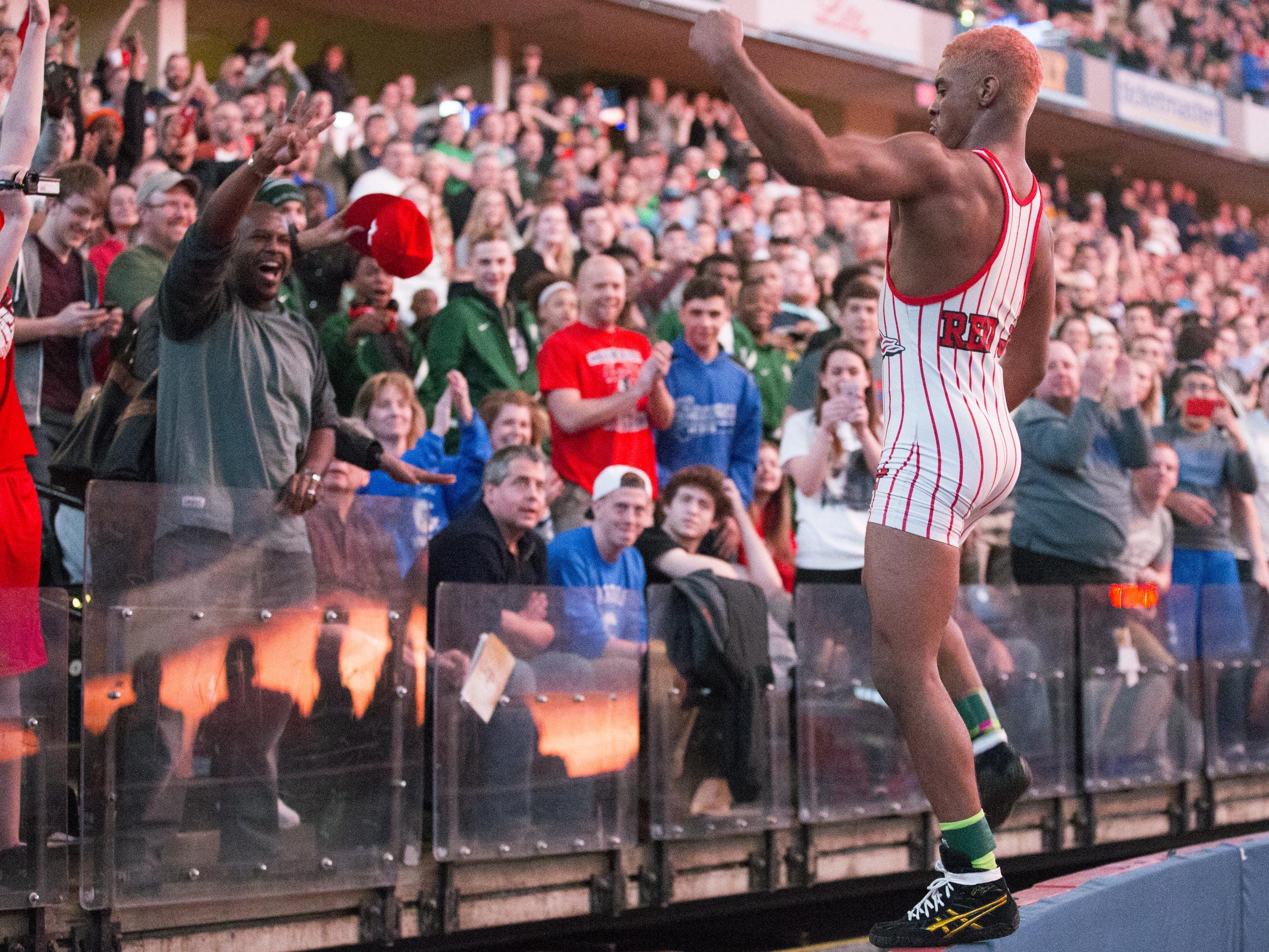 Chad Red ofNew Palestine High School, hops on a wall to greet fans after he beat also-undefeated 132 point wrestler Nick Lee, Evansville Mater Dei, IHSAA Wrestling State Finals, Bankers Life Fieldhouse, Indianapolis, Saturday, Feb. 20, 2016. Red finished his pre-collegiate career undefeated.