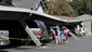 People look at some of the more than a dozen vehicles damaged when the carport at the Charter Oaks apartment complex collapsed during an earthquake in Napa, Calif.