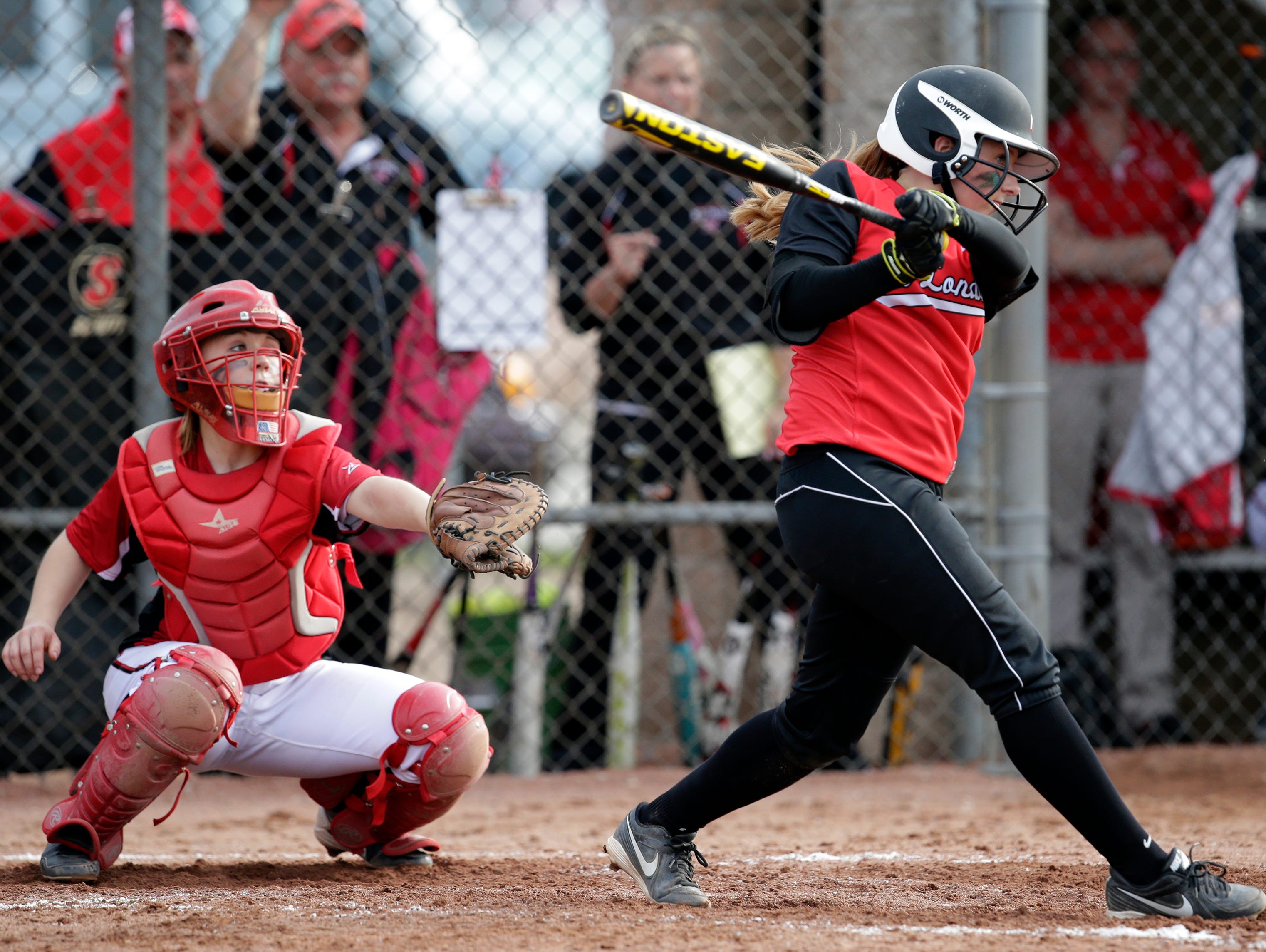 New London's Alanna Beyer (right) drives in a run against Hortonville High School during a Bay Conference softball game May 8, 2014 at Hortonville.