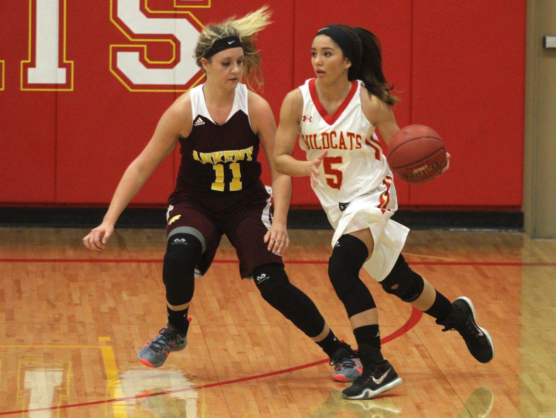 Ankeny junior Codee Myers defends against Carlisle sophomore Amber Kettering. Class 4A 15th-ranked Carlisle beat Ankeny 57-44 in the Wildcats' home opener on Nov. 24.