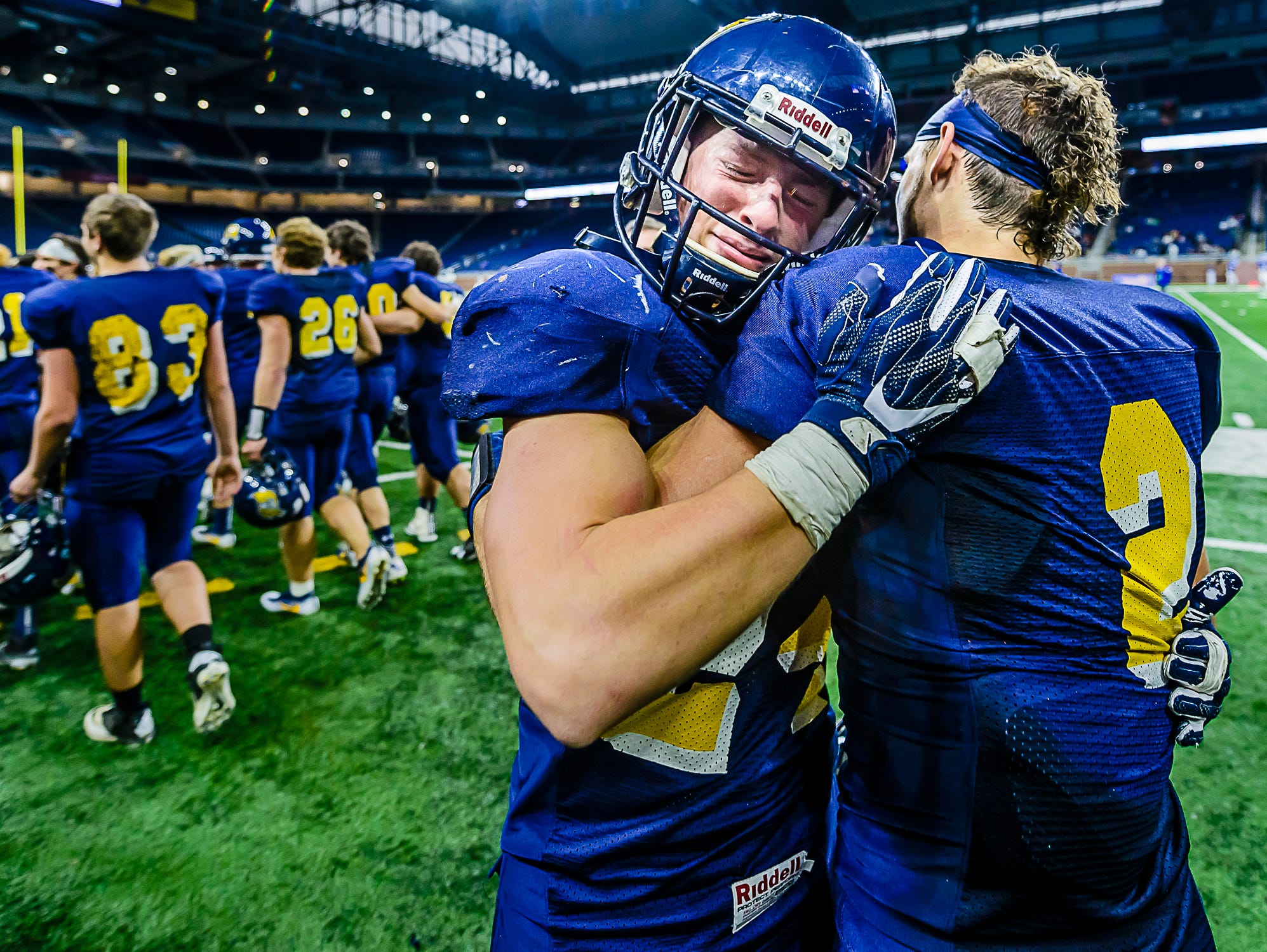 Pewamo-Westphalia senior tight-end Nathan Smith, left, hugs teammate Mason Schneider after their Division 7 state final win over Detroit Loyola Saturday November 26, 2016 at Ford Field in Detroit.