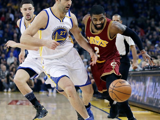 Cleveland Cavaliers' Kyrie Irving, right, and Golden State Warriors' Zaza Pachulia (27) chase a loose ball during the first half of an NBA basketball game Monday, Jan. 16, 2017, in Oakland, Calif. (AP Photo/Ben Margot)