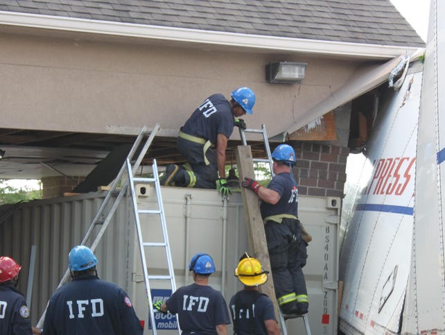 u.s. express truck backs into building overhang in Indianapolis IN