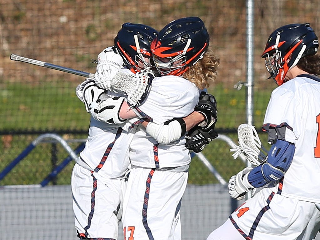 From left, Briracliff's Michael DeGasperis (2) jumps into the arms of teammate Peter Olson (17) after a 4th quarter goal against Pleasantville during a lacrosse game at Briarcliff High School April 20, 2016. Briarcliff won the game 8-7.