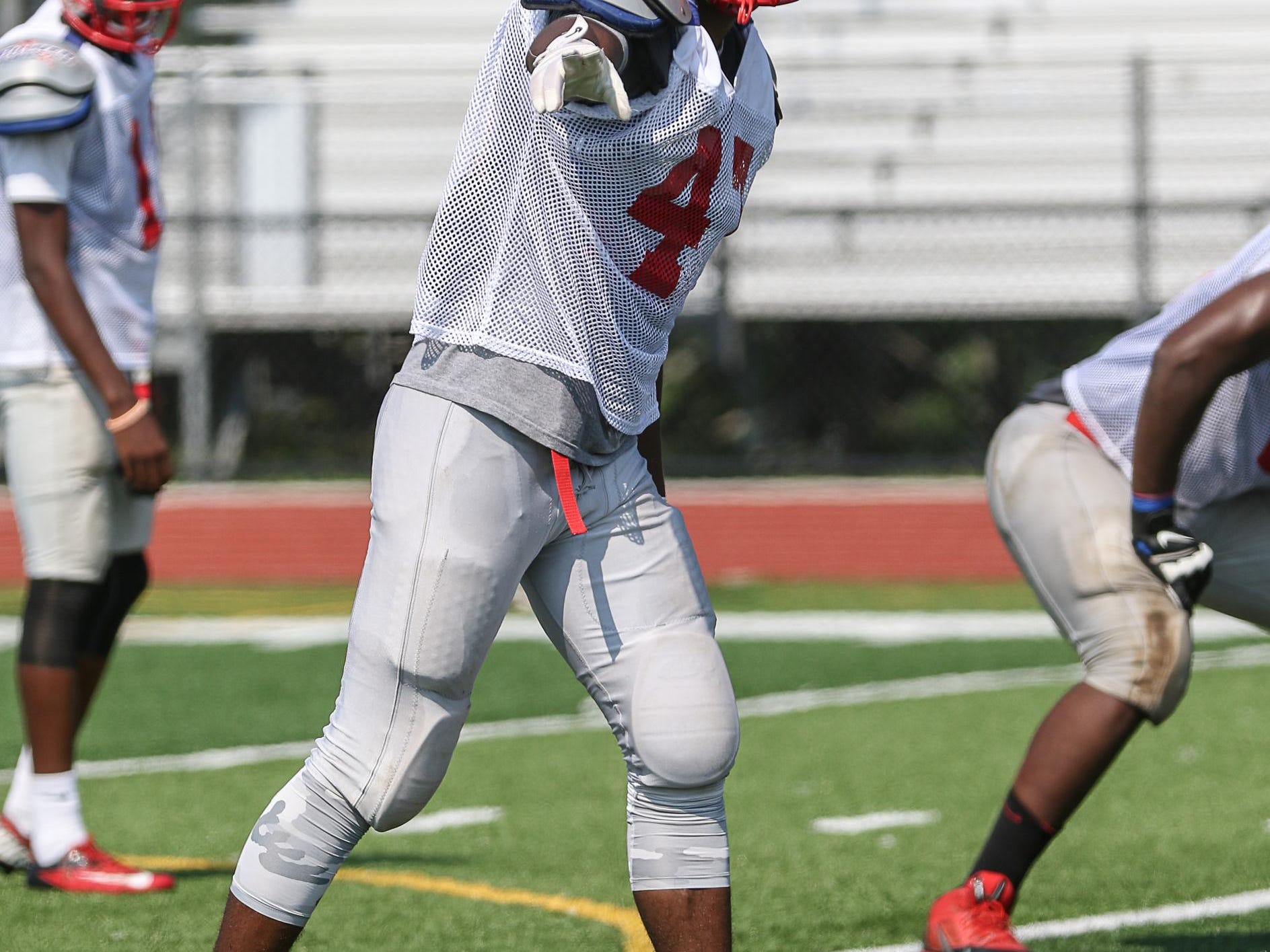 Cesar Cordoba checks his position with the official during a Plainfield scrimmage at J.F. Kennedy.