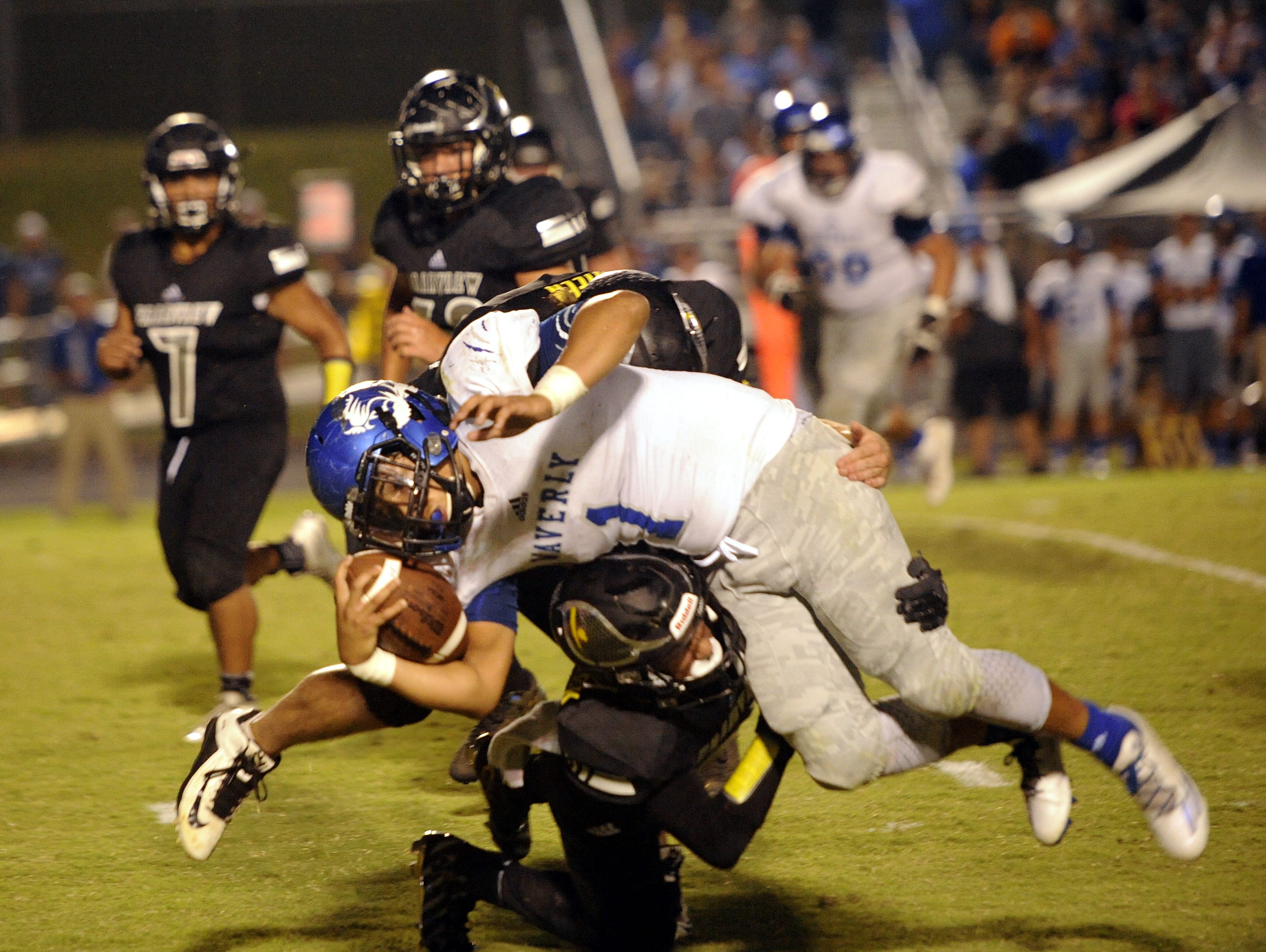 Waverly junior running back Michael Jackson is upended by Fairview junior Khristain Harris-Lusk.