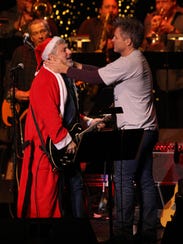 Jon Bon Jovi performs with Bobby Bandiera during the