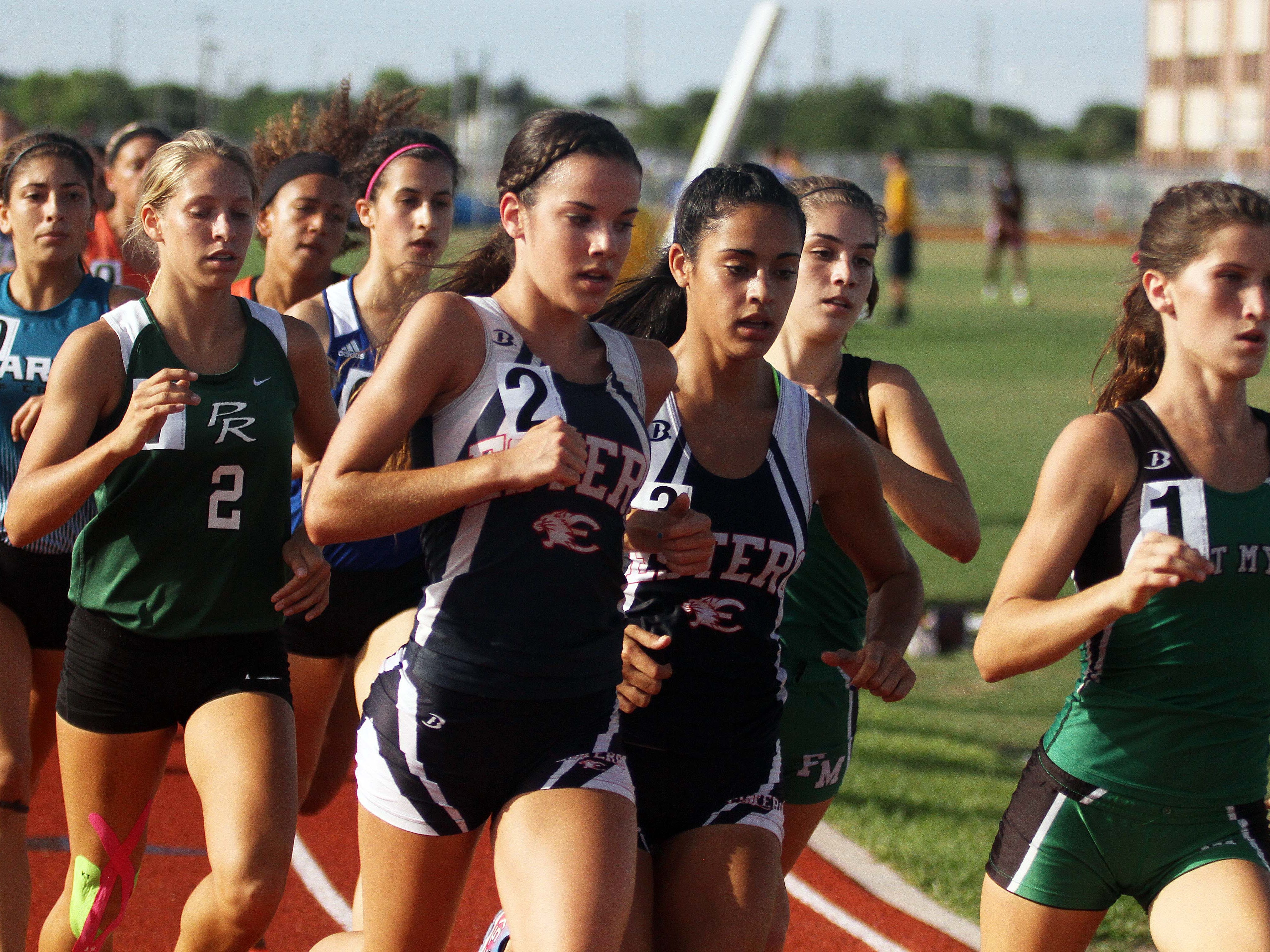 Fort Myers' Kristlin Gear, right, leads the pack during the girls’ 1,600-meter run Thursday at the Region 3A-3 track meet at Charlotte High School. Gear won the race in 5:12.04.