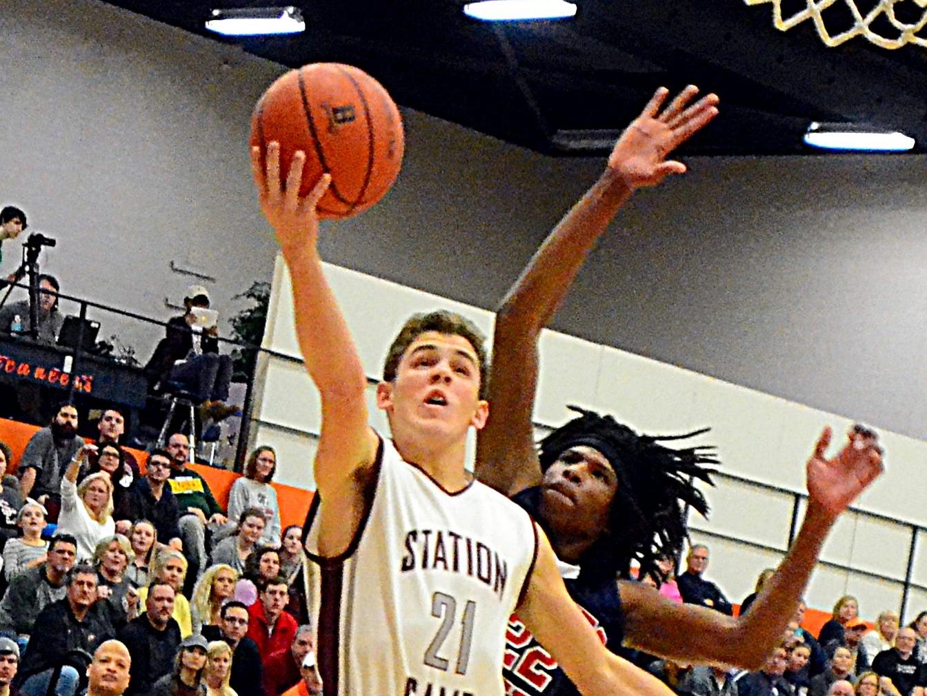 Station Camp High junior Thomas Zazzaro elevates for a layin against Whites Creek junior JaQuan Brooks during second-quarter action.