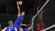 Russia wing spiker Dimitry Volkov (7) hits against