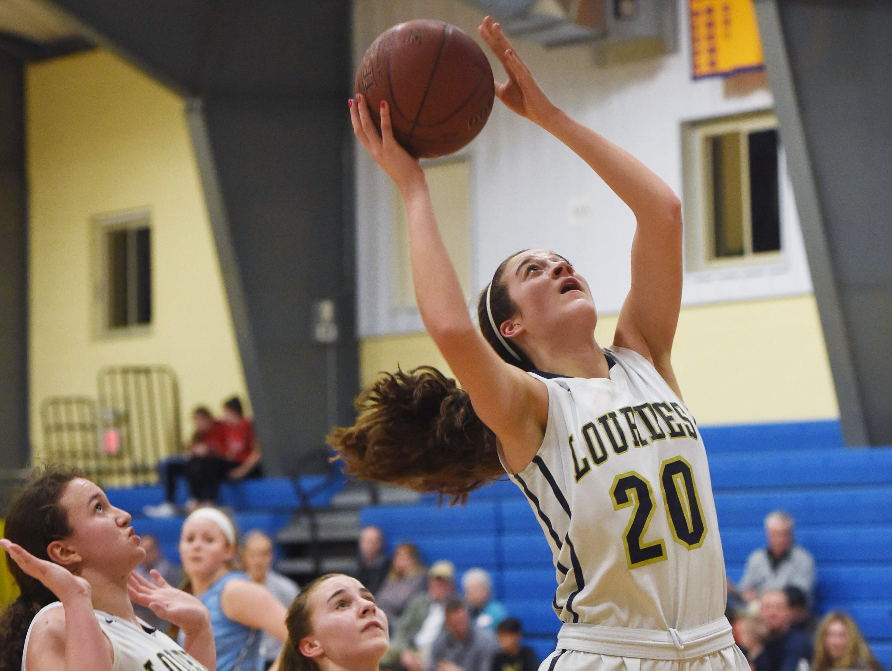 Lourdes' Madison Siegrist, right, goes for a layup during Friday's game against Suffern.