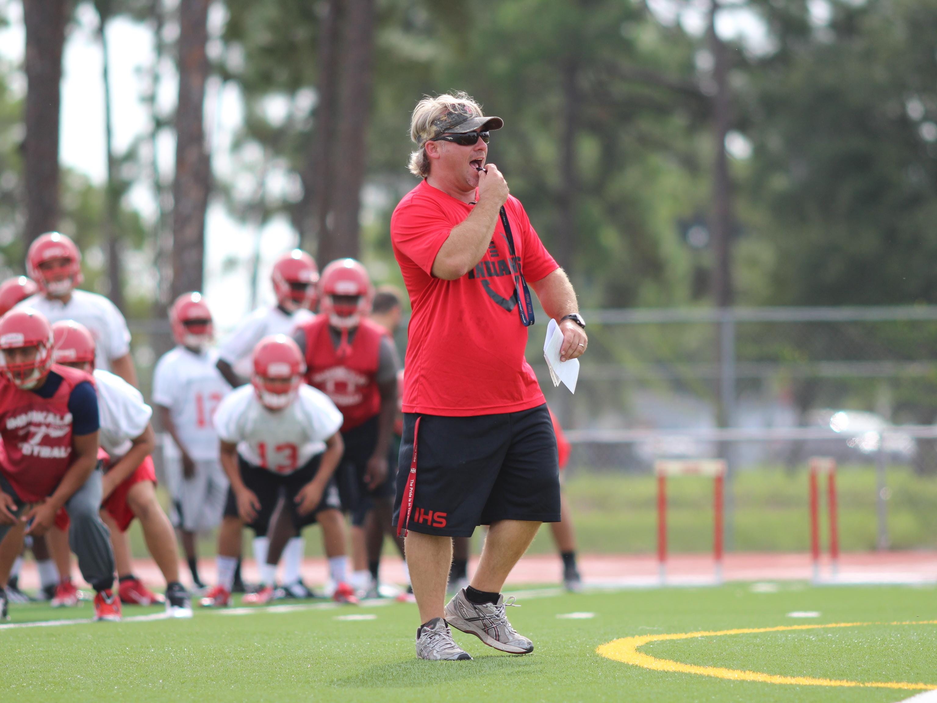 New Immokalee head coach Dale More runs drills during practice Monday morning.