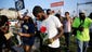 Protesters move down the street, many carrying roses in Ferguson, Mo.
