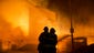 Firefighters battle a blaze after rioters plunged part