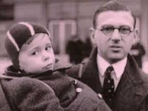 Stockbroker Nicholas Winton holds a young boy during