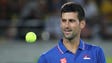 Novak Djokovic (SRB) catches a ball during his match