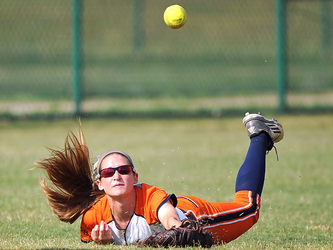 Dickson County's Savannah Mathis goes all out to try and snag a short pop up in left field in the Class AAA softball championship game on May 27, 2016.