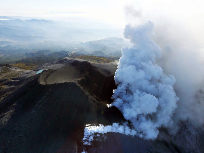 Plumes of smoke and ash billow from Mount Ontake as it continues to erupt in central Japan, on Sunday, Sept. 28.