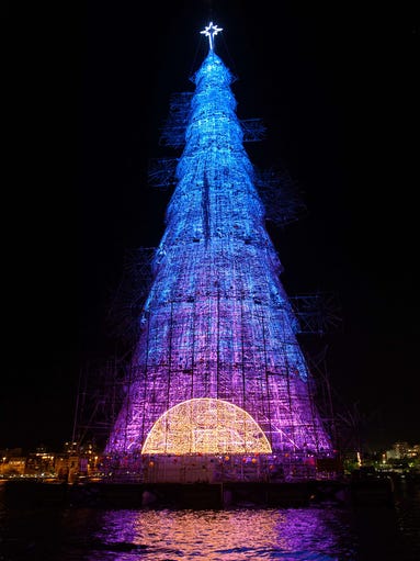 A 85-meter-high floating Christmas tree illuminates