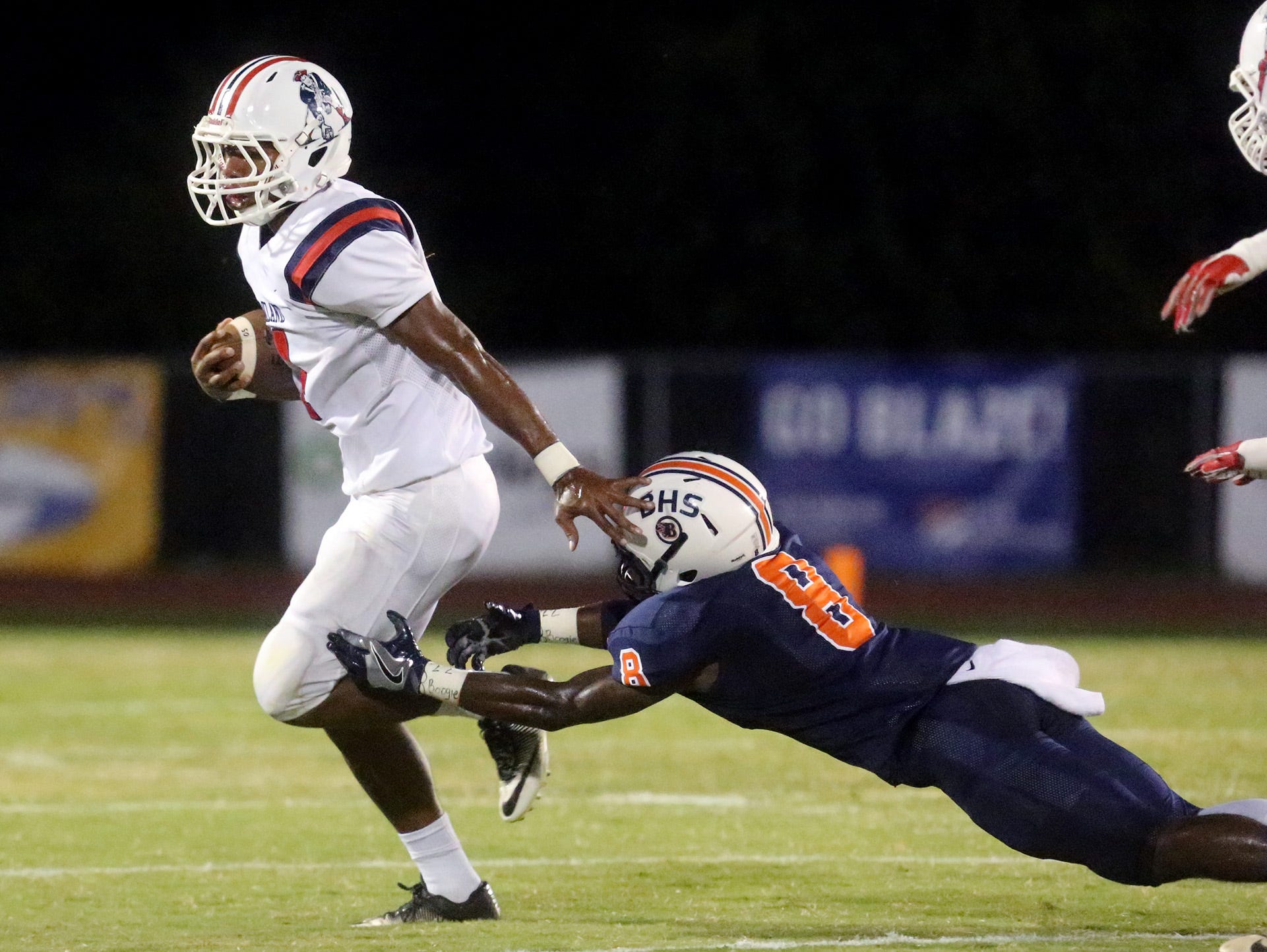 Oakland's Lazarius Patterson (4) runs the ball as Blackman's Jamis Carson (8) misses a tacke during the game on Friday, Sept. 16, 2016, at Blackman.