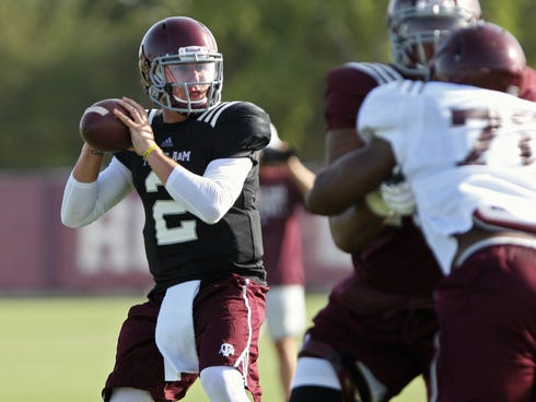 Texas A&M quarterback Johnny Manziel continues to practice with the Aggies team as the NCAA investigates allegations he was paid for signing his autograph.