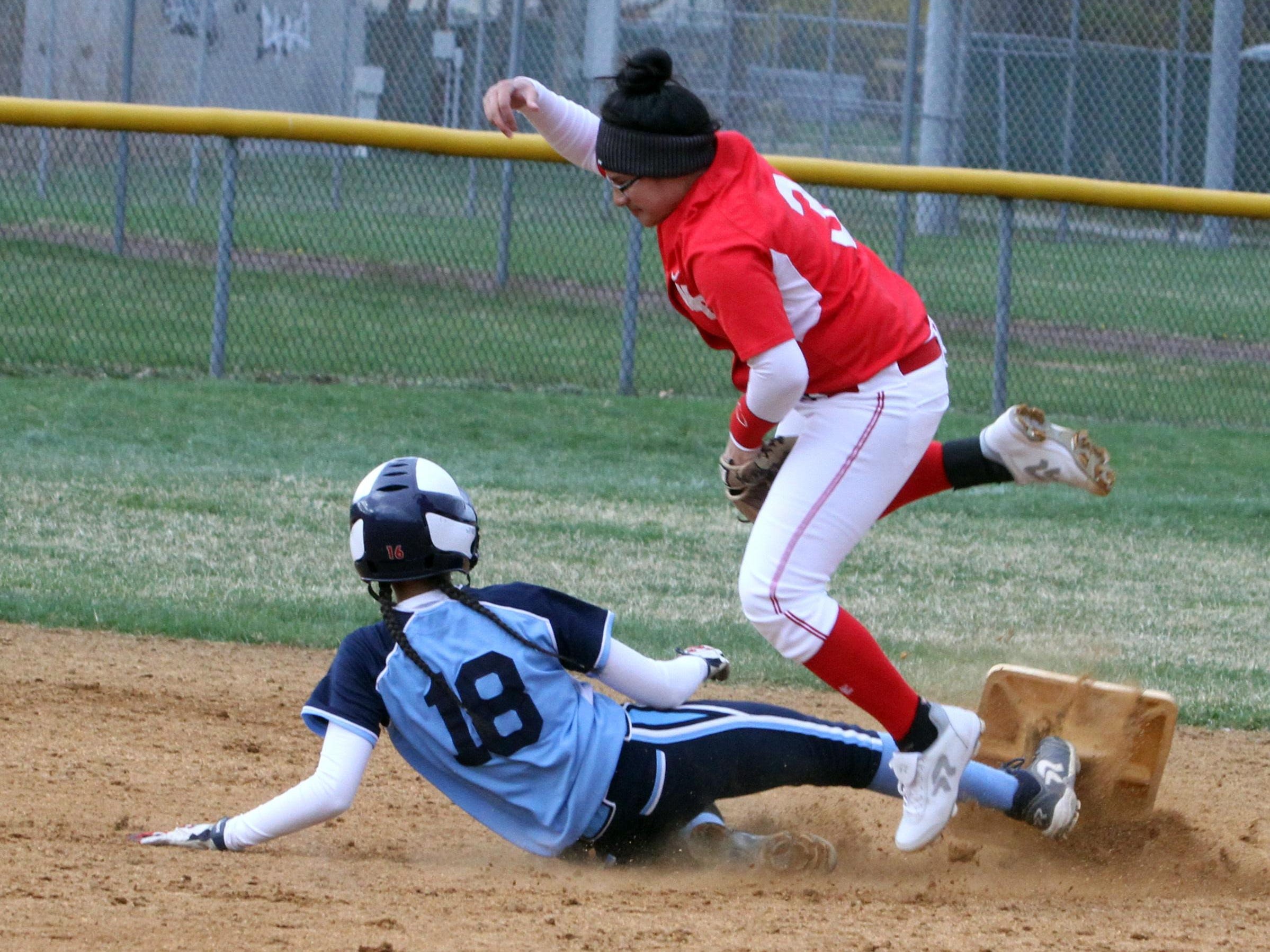 Second base goes flying as Ursuline's Korina Guerra was caught stealing by North Rockland's Deangie Jimenez during a varsity softball game at North Rockland High School April 7, 2016. North Rockland defeated Ursuline 6-5.