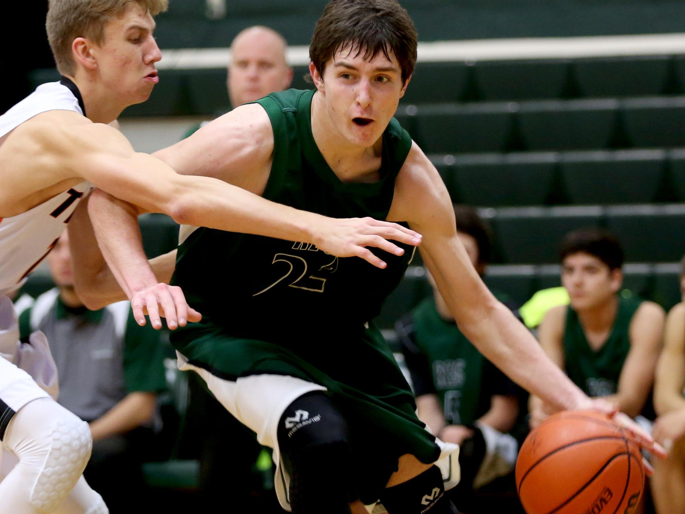 Regis' Sam Nieslanik (22) drives past Yamhill-Carlton's Jackson Harloof (13) in the second half of the Regis vs. Yamhill-Carlton boy's basketball game in the first round of the North Marion Holiday Classic at North Marion High School in Aurora on Thursday, Dec. 17, 2015. Regis won the game 59-44 and moves on to play in the semifinals at 8 p.m. on Friday.