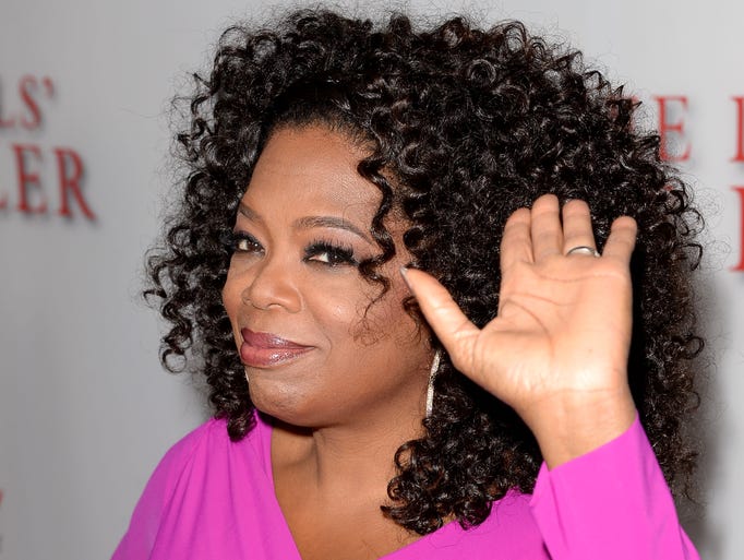 Oprah Winfrey waves her left hand at the premiere of The Weinstein Company's "Lee Daniels' The Butler" at Regal Cinemas L.A. Live in 2013.