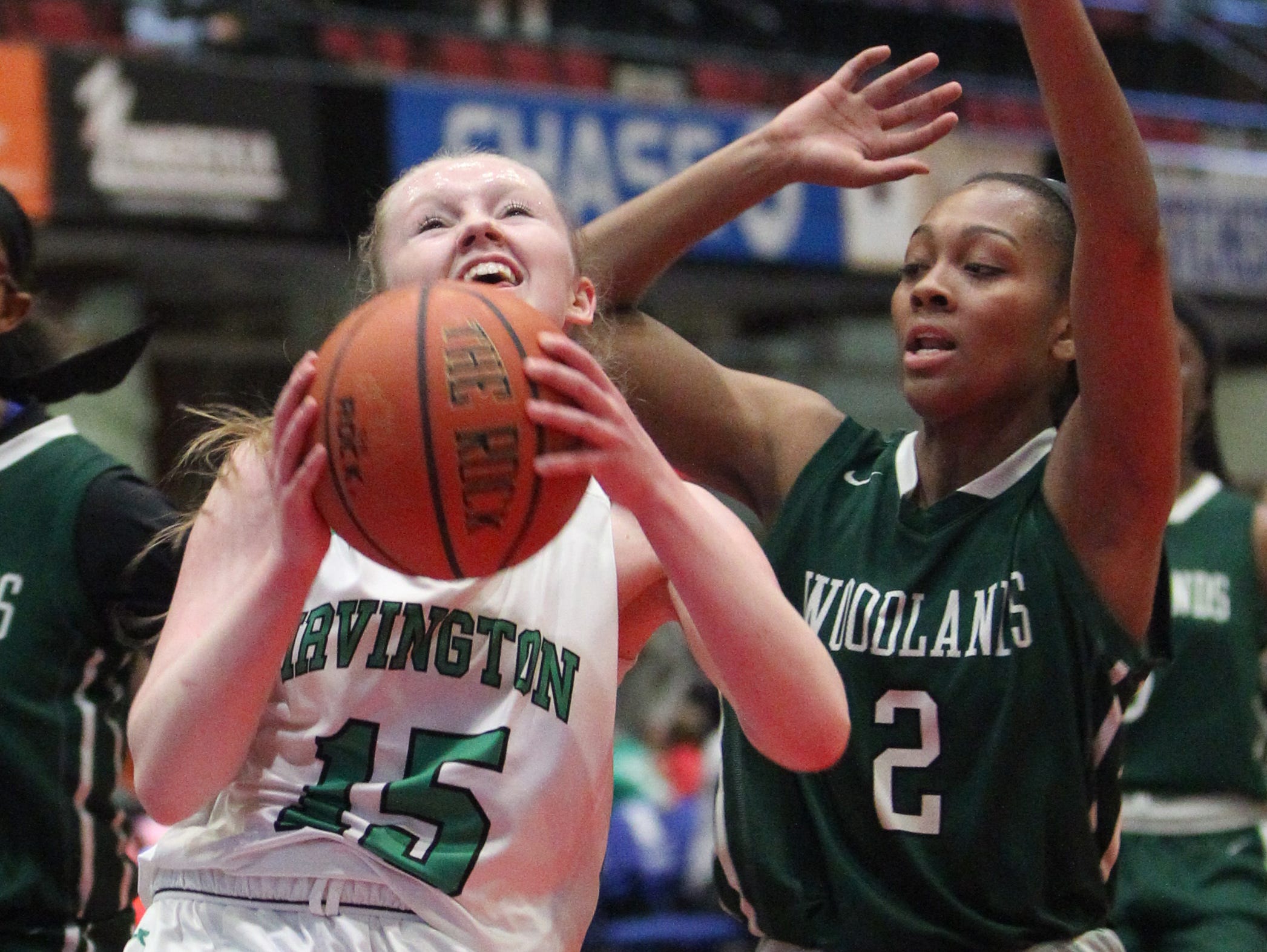 Irvington's Lindsay Halpin is pressured by Woodlands' Haley Buckland during the Class B final at the Westchester County Center Feb. 29, 2016. Irvington won 77-68.